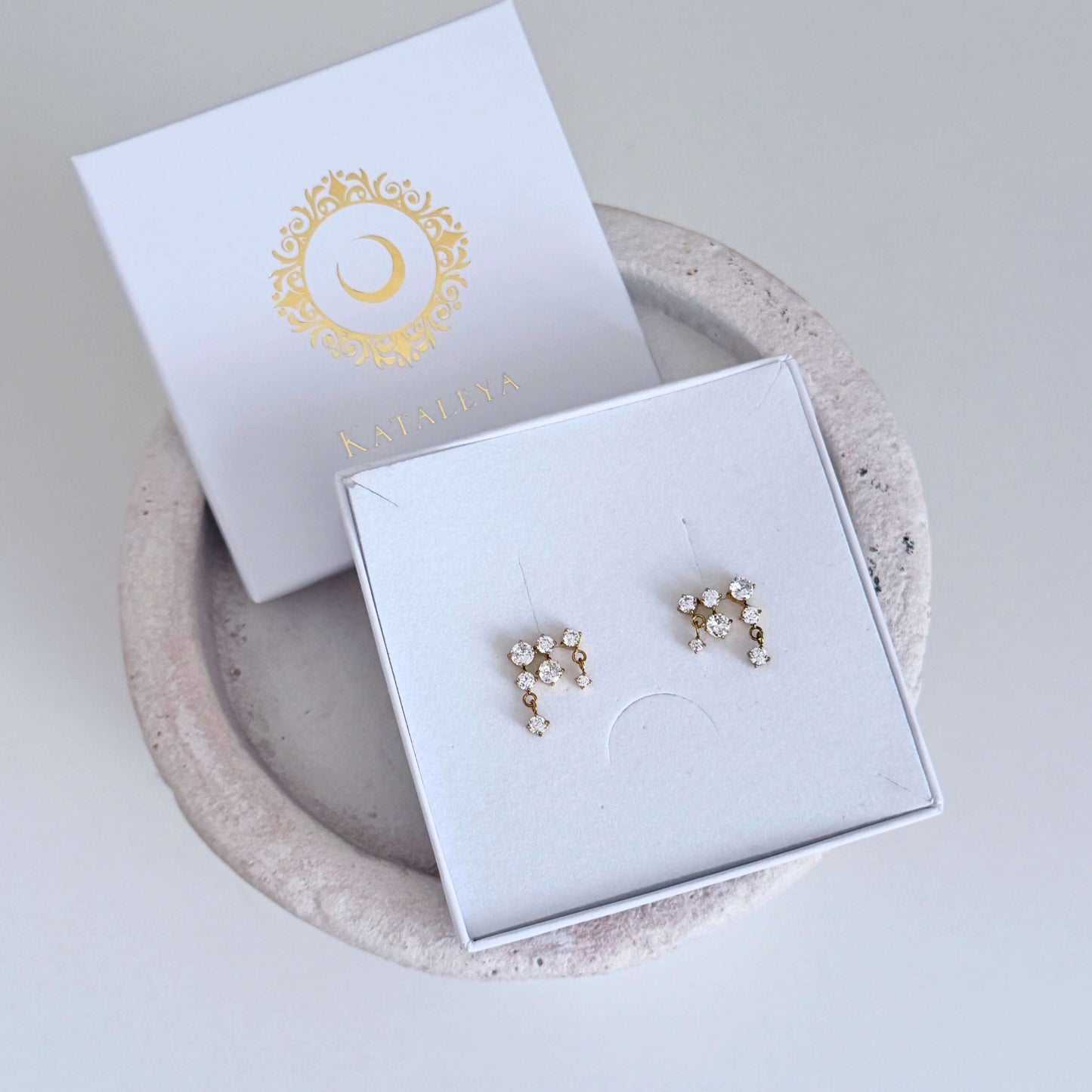 Demeter Eos Stud Set displayed in a jewelry box featuring Gold Zircon Stud Earrings with sparkling design.
