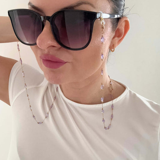 Woman wearing black sunglasses with a stylish Colourful Glasses Chain in a chic outfit.