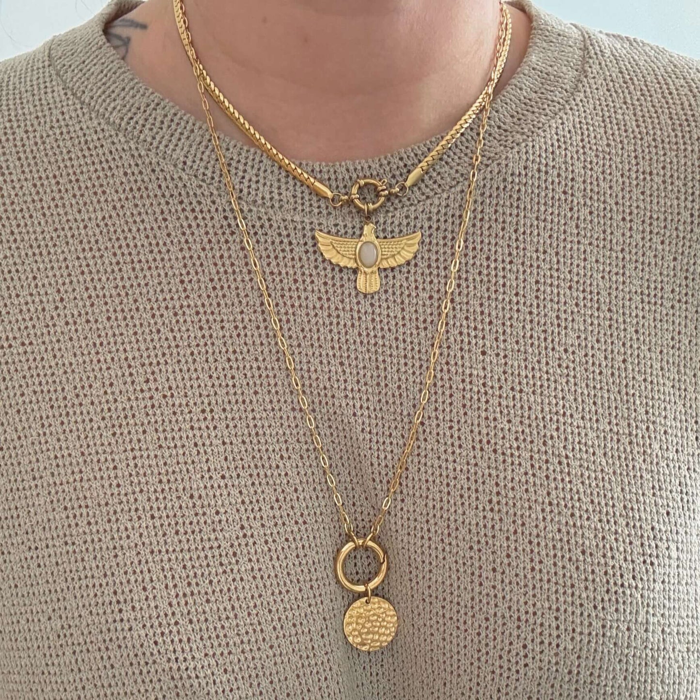 Two layered necklaces featuring a textured coin pendant and an elegant charm, showcasing the Coin Carabiner Necklace style.