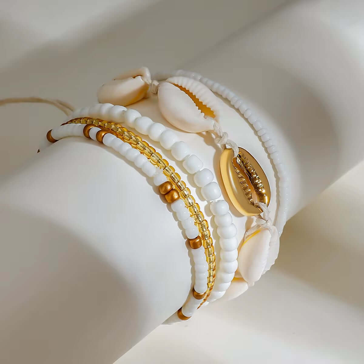 Set of Five white and gold beaded, shell bracelets on a string by Kataleya