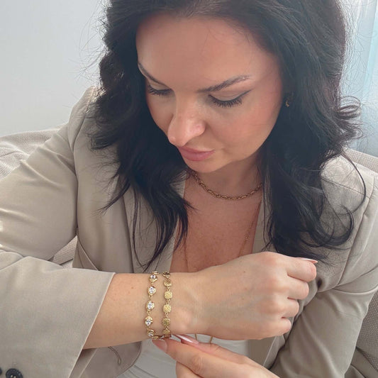 Woman wearing a Kora waterproof bracelet with zircon stones, showcasing its elegant design and features.