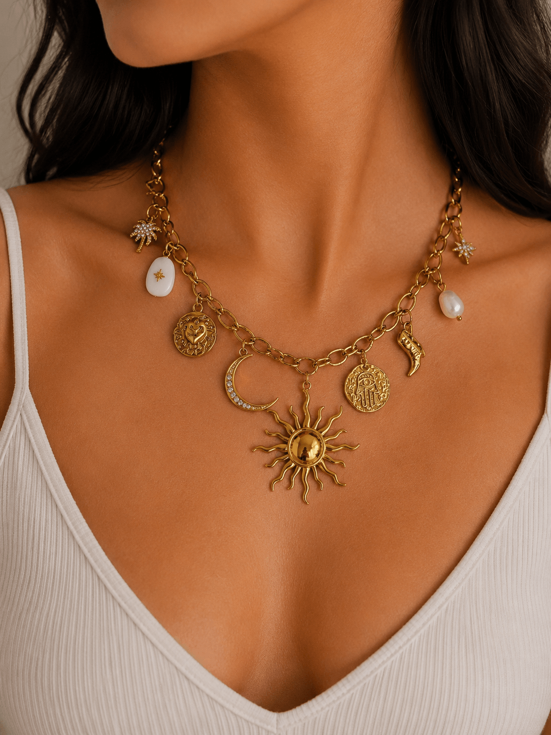 Close-up of a woman wearing an Asteria Charm Necklace, featuring celestial charms and a sun pendant, symbolising protection and intuition.