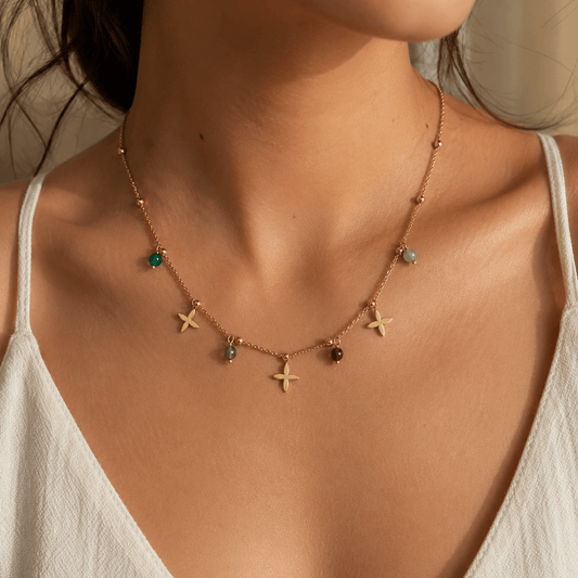 Huacachina Necklace - Colourful Beaded Necklace with gold and vibrant beads worn by a model.