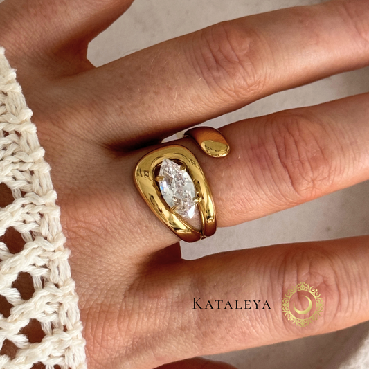 Gold Bold Crystal Wrap ring with a diamond on a person's finger, brand 'Kataleya' visible by Kataleya Jewellery