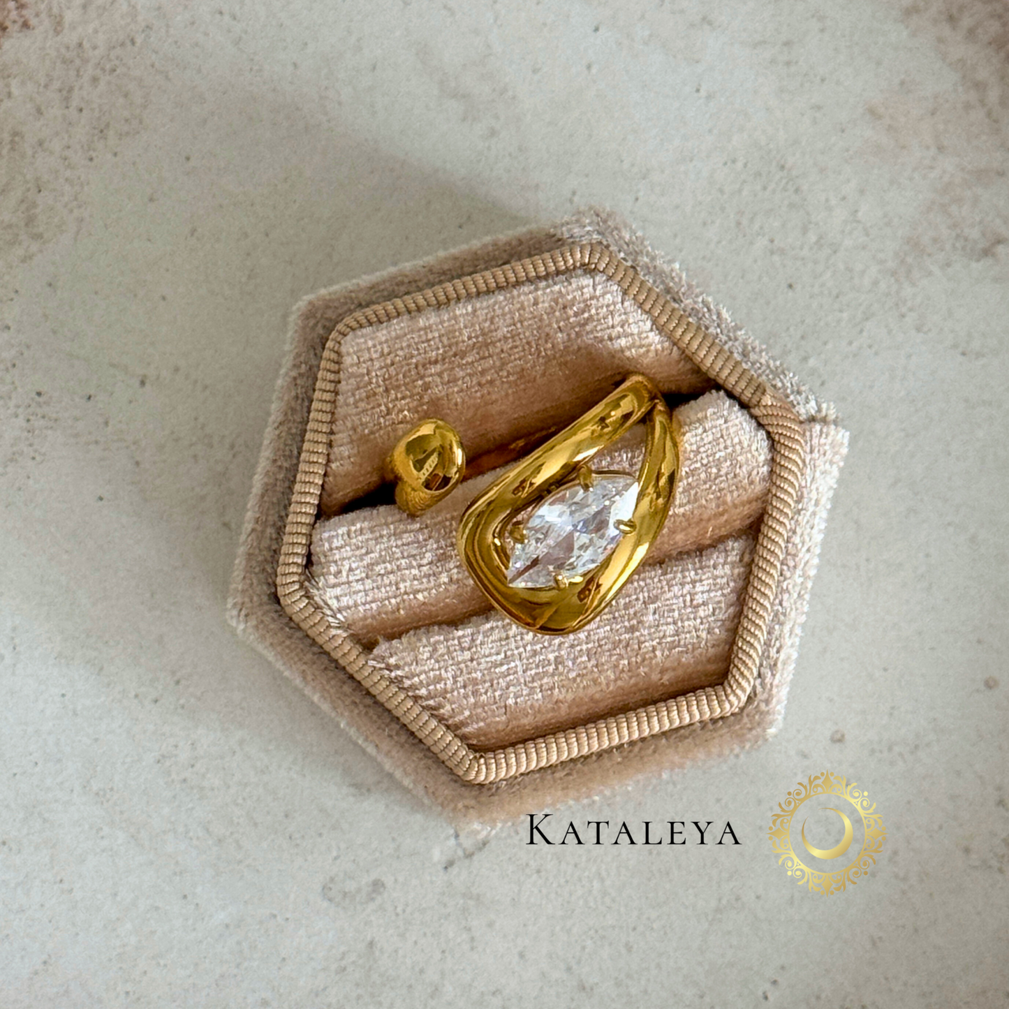 Bold Crystal Wrap Ring displayed in an elegant hexagonal box showcasing its oversized zircon crystal and gold twist band.