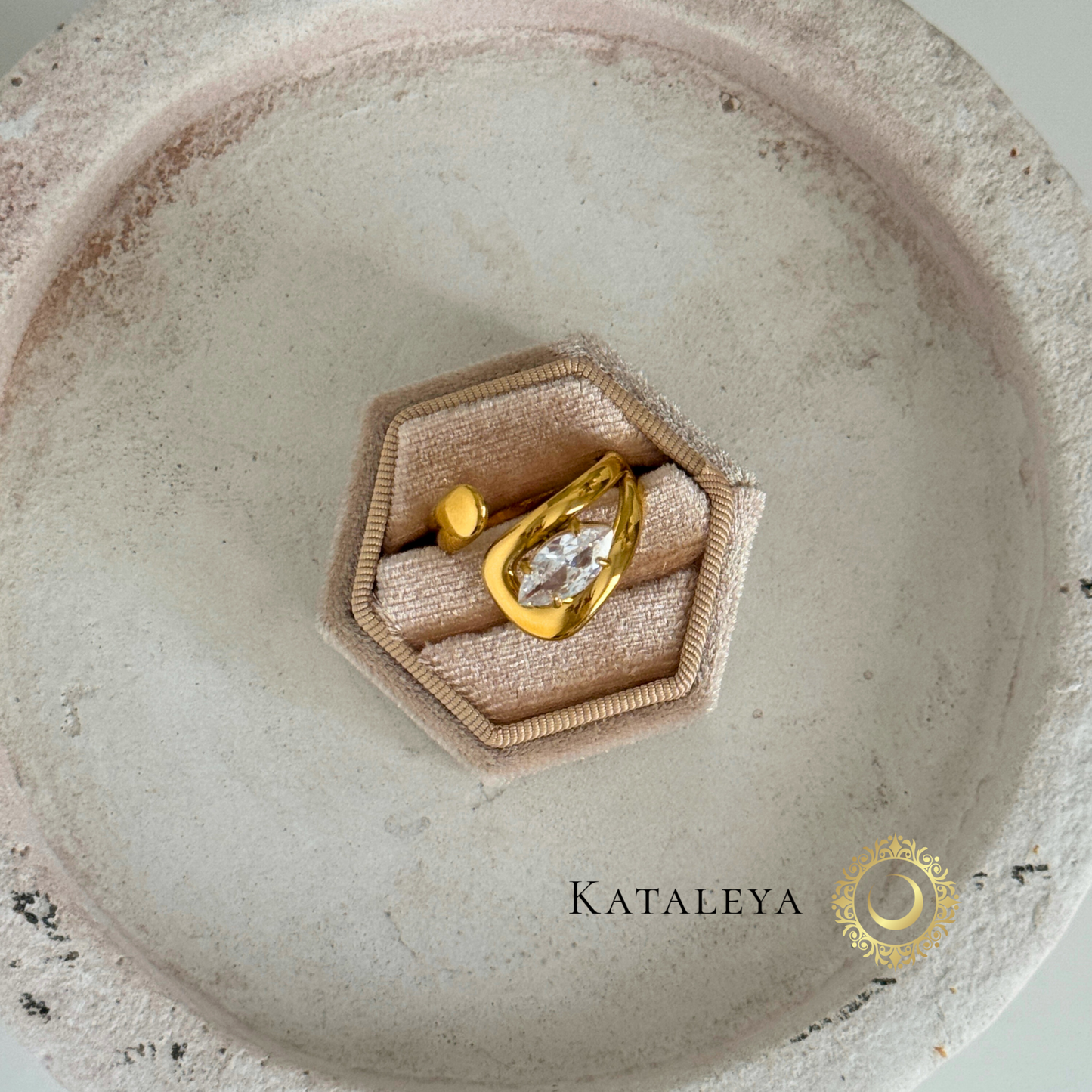 Bold Crystal Wrap Ring displayed on a soft velvet ring holder with a gold twist band and oversized zircon crystal.