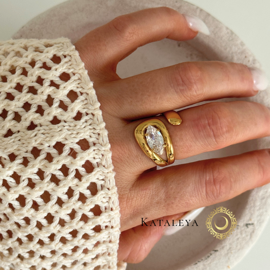 Bold Crystal Wrap Ring on a hand, showcasing a large zircon crystal and sleek gold band, waterproof and tarnish free.