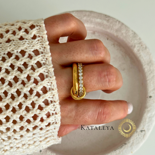 Crystal Stack Ring - two gold interlocking rings, one with zirconia stones on a finger by Kataleya Jewellery