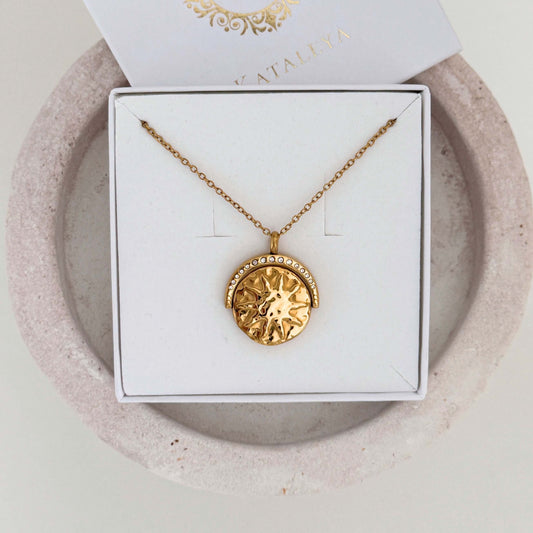 Spinner Sun Necklace on display with gold pendant featuring sun design and sparkling zirconia stones