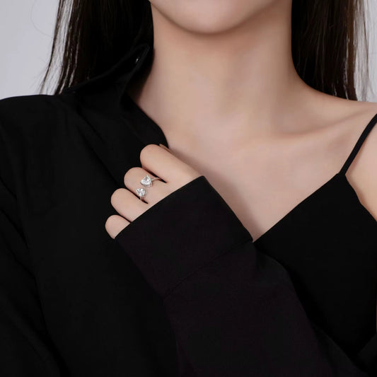 Model wearing the Eliza Toi Et Moi Ring featuring a heart and waterdrop diamond, styled in a black outfit.