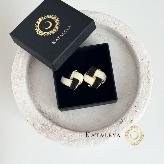 Noir Chic Enamel Earrings in luxurious packaging on a decorative tray, featuring a bold black and white design.