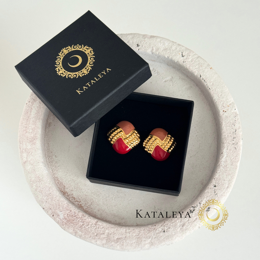 Flame Enamel Earrings displayed in a stylish box, featuring vibrant red and orange enamel with gold accents.