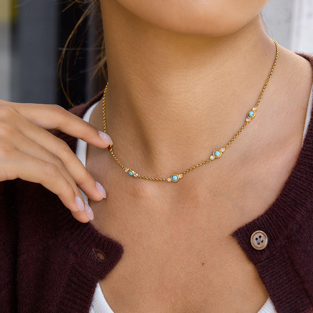 Gold Turquoise Necklace worn by a woman, featuring delicate turquoise and crystal details.
