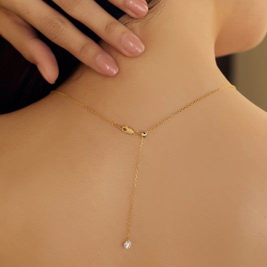 Seraphine Halo Necklace with sparkling zirconia, gold plated sterling silver chain worn on a woman's neck.
