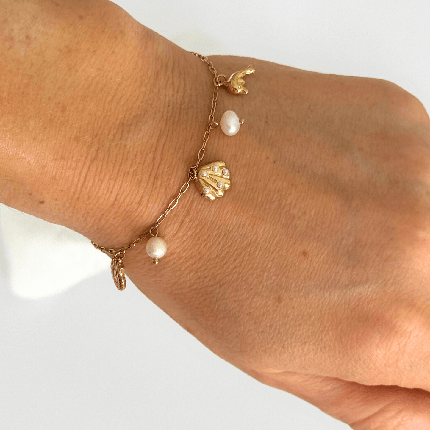 Dainty gold ocean charms bracelet with pearls by Kataleya Jewellery