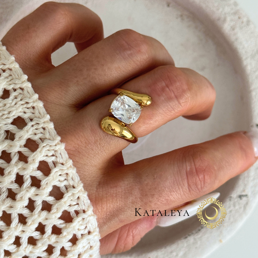 Elegant hand wearing a gold Twist Diamond Ring with a clear stone, showcasing modern design and timeless style.