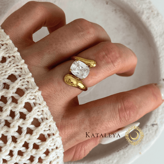 Elegant hand wearing a gold Twist Diamond Ring with a clear stone, showcasing modern design and timeless style.