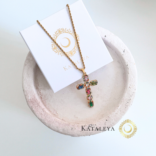 Multicolor Cross Necklace displayed on a round dish, featuring a shimmering cross pendant and elegant twisted rope chain.