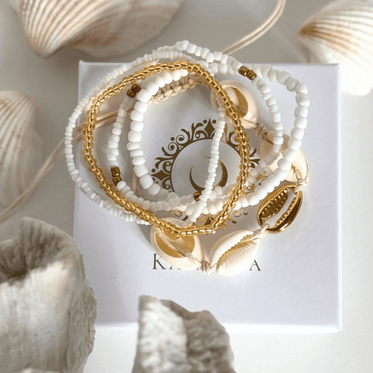 Set of Five white and gold beaded, shell bracelets on a string by Kataleya