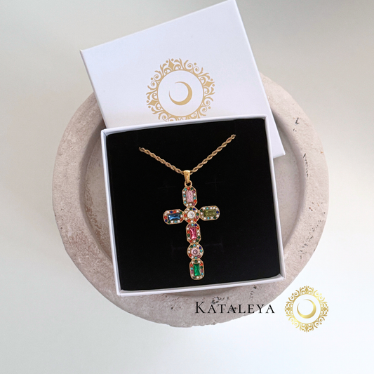 Multicolor Cross Necklace displayed on a black cushion with a gift box, showcasing vibrant crystals and gold chain.