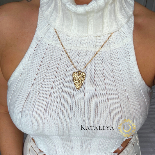 Sculpted Heart Long Necklace worn with a stylish white turtleneck, showcasing its unique design and waterproof quality.