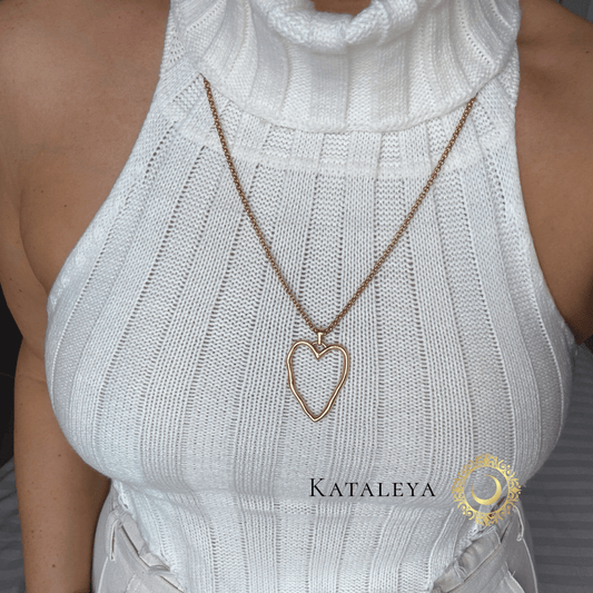 Heart of Gold Long Necklace worn with a white knit top, showcasing the elegant open-heart pendant.