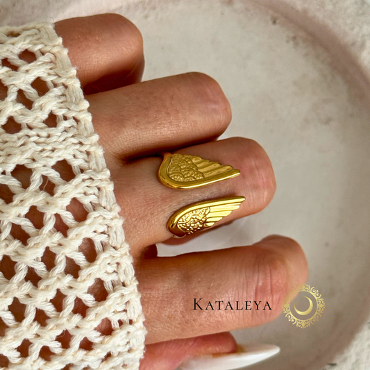 Winged Goddess Ring shown on a hand, featuring intricate wing detailing and a bold gold finish.