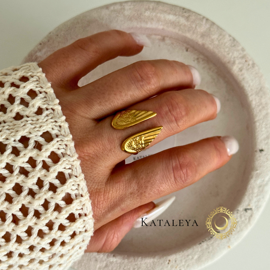 Winged Goddess Ring featured on a hand, showcasing intricate wing design in gold finish, waterproof and tarnish-free.