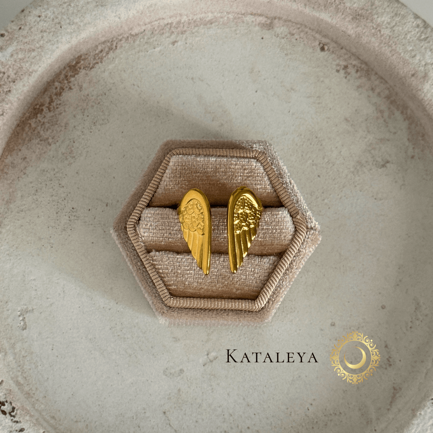 Winged Goddess Ring displayed on a hexagonal ring box, showcasing gold wing details and elegant design.