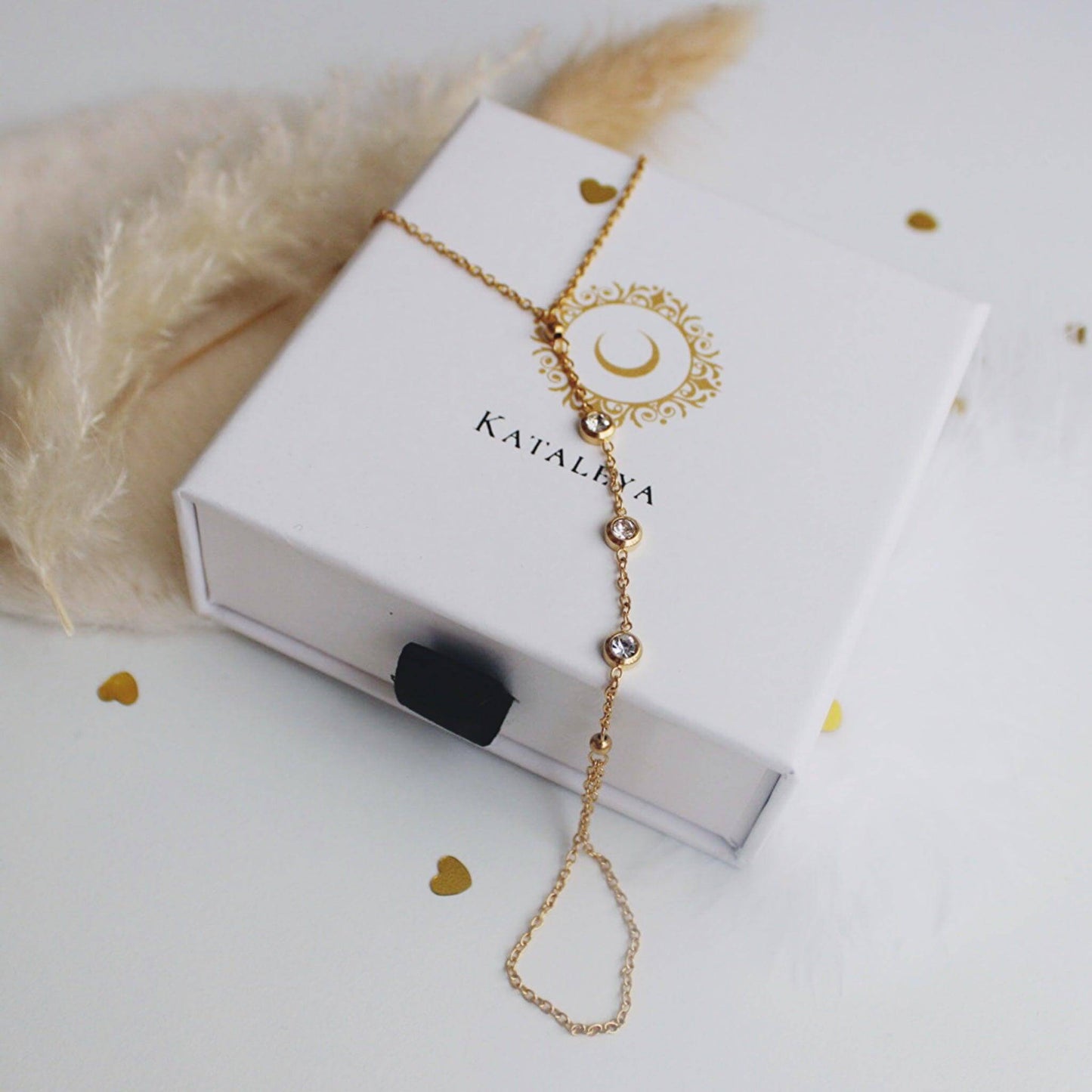 Anaia Zirconia Finger Bracelet presented in branded packaging with gold accents and sparkling details.