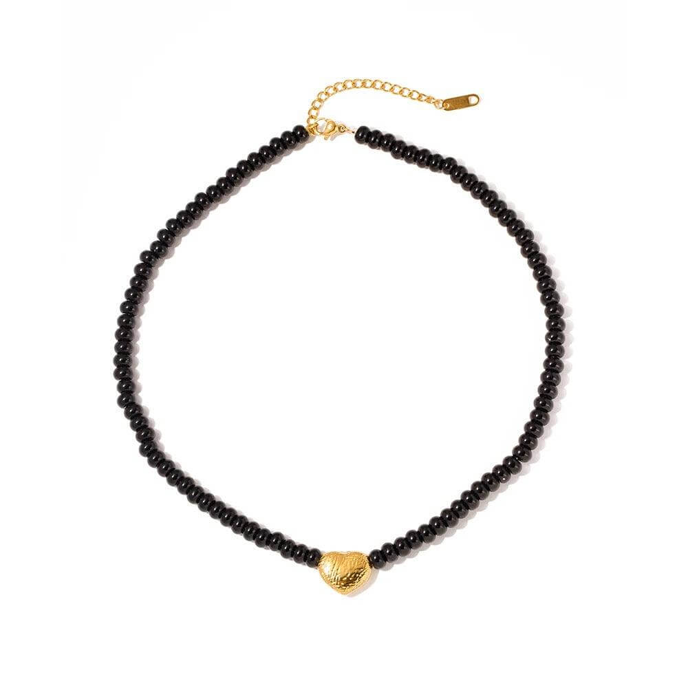 Beaded Heart Necklace featuring a black beaded choker and gold heart pendant, perfect for adding elegance to any outfit.