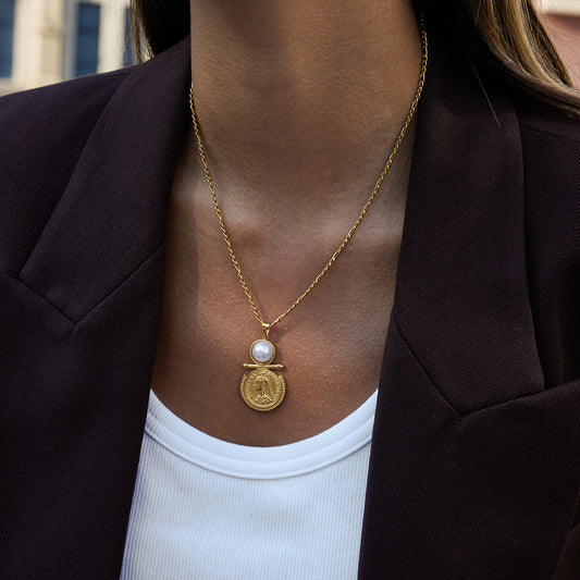 Aura Coin Pearl Necklace displayed on a model, featuring a pearl and a Queen Victoria medallion design.
