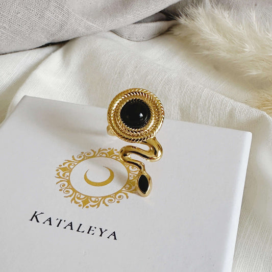 Chic gold plated Snake Agate Ring with black agate stone, displayed on a Kataleya branded box.