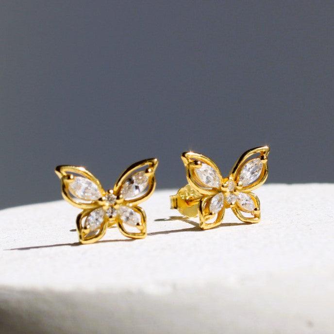 Elegant butterfly stud earrings in 18ct gold plating with shimmering zirconia, perfect for adding grace to any outfit.