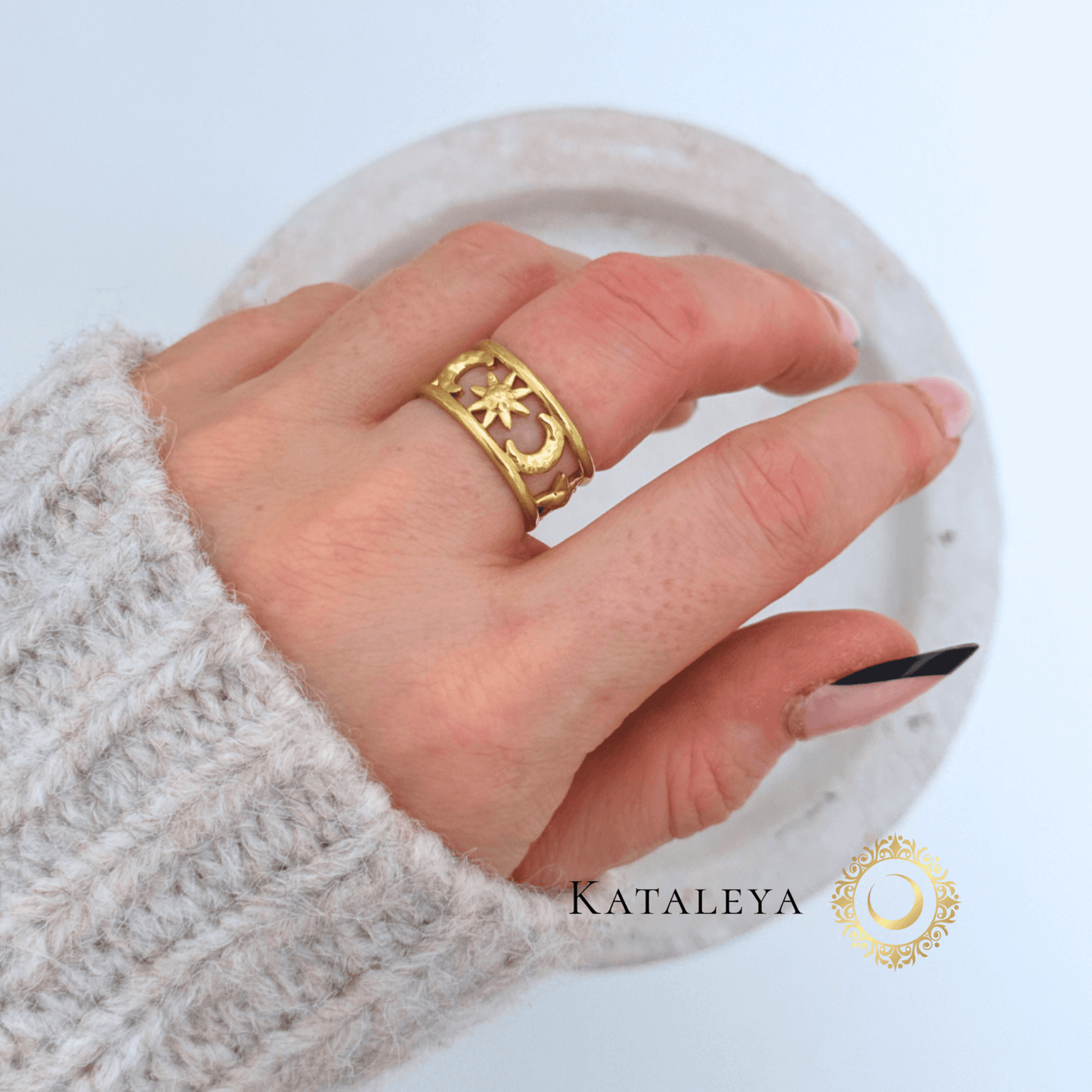 Celestial Harmony Ring worn on a hand with a gold-plated design, showcasing its waterproof and stylish features.