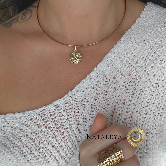 Coin Wire Choker worn on a model highlighting the textured coin pendant and sleek gold wire design.
