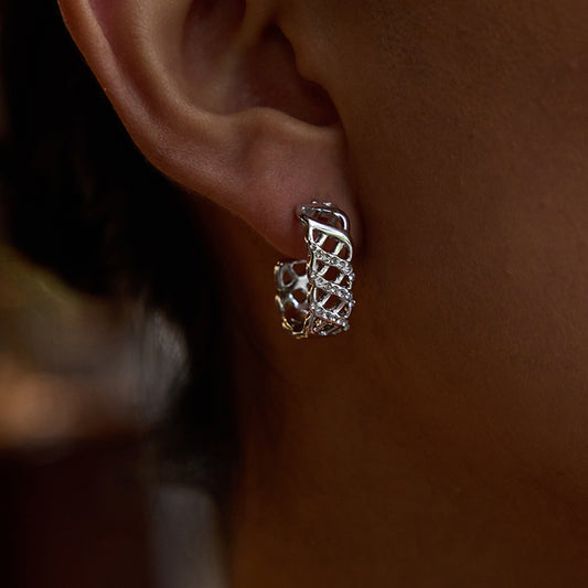 Crystal Lattice Earrings showcased on an ear, featuring a delicate lattice design with zirconia crystals.