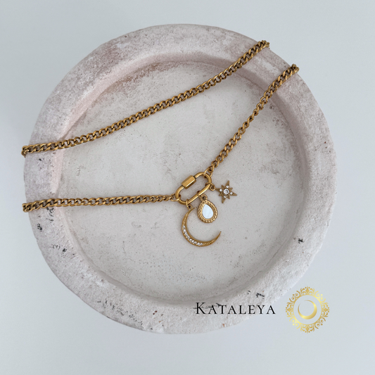 Oval Carabiner Charm Necklace displayed on a minimalist plate, showcasing its gold-plated design and unique charm.