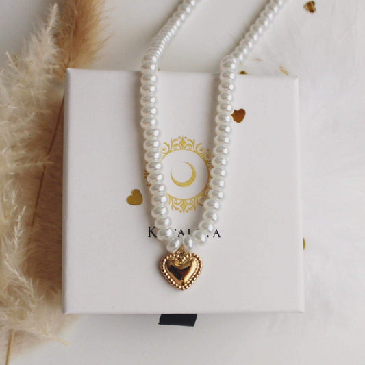 Heart pearl necklace featuring a gold heart pendant, elegantly displayed in a gift box.