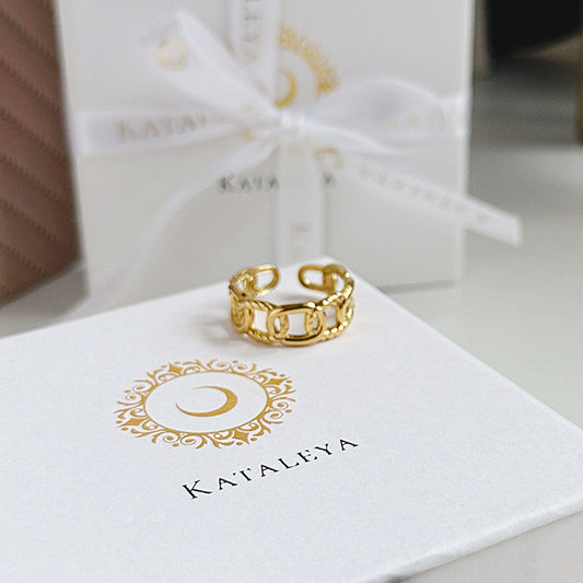 Knot Band Ring in gold on a gift box, showcasing adjustable design and high-quality craftsmanship.