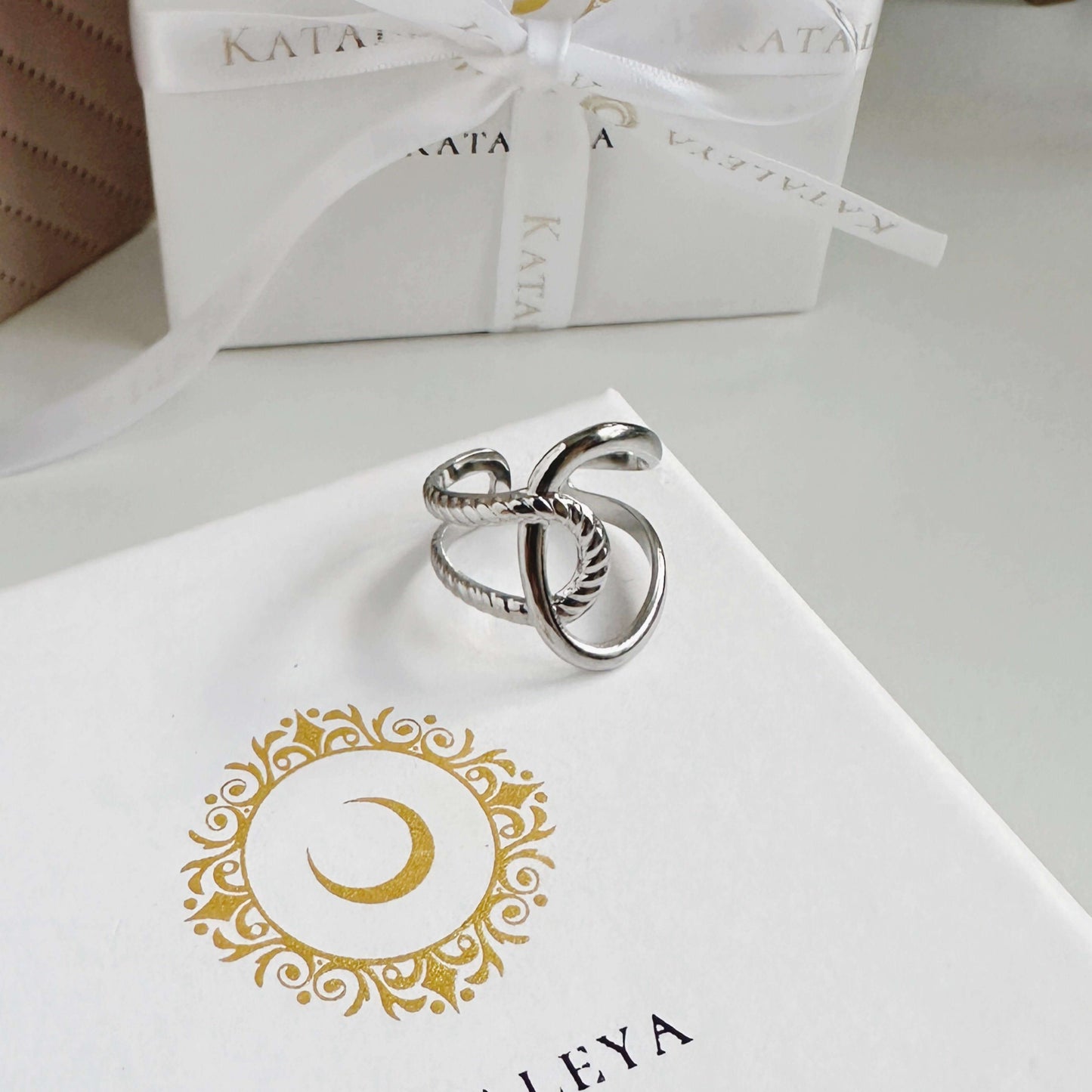 Knot Silver Ring displayed on gift box with elegant design, showcasing its unique knot style and adjustable feature.