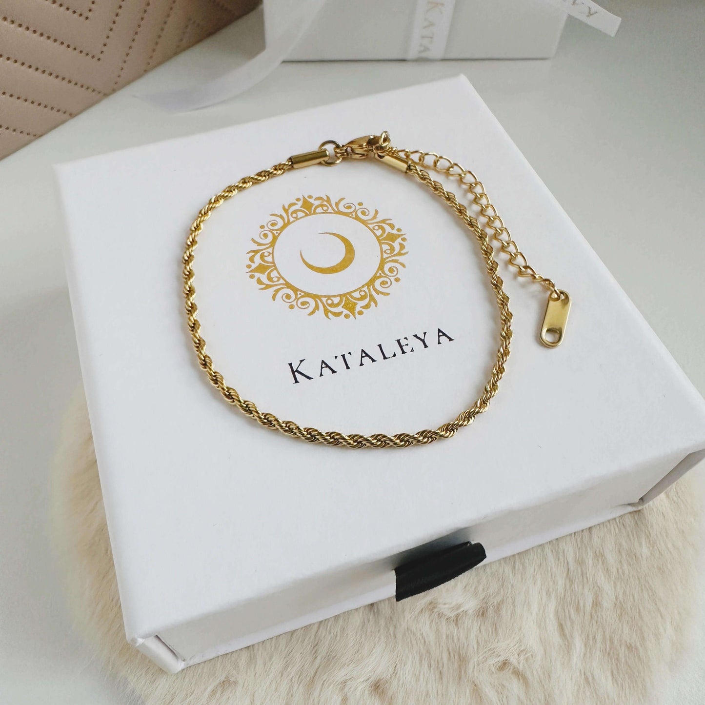 Twisted Chain Bracelet in gold on a Kat ALEYA box, showcasing an elegant and sophisticated design for any outfit.