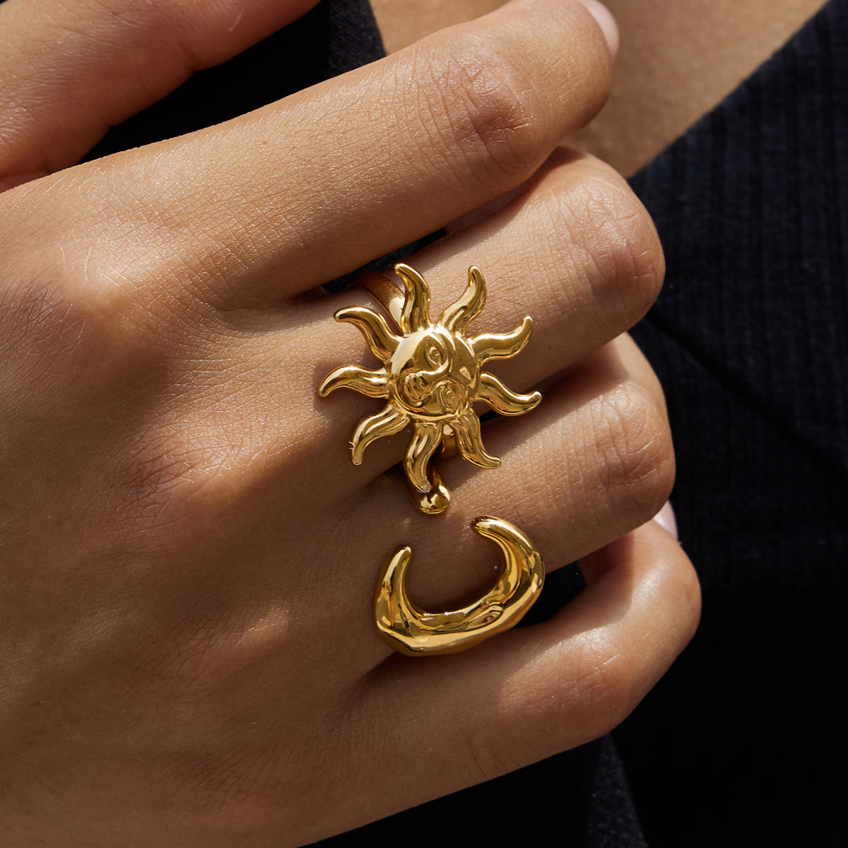 Chunky Gold Moon Ring And Chunky Gold Sun Ring on a hand featuring sun and moon design details, showcasing a unique gold accessory.