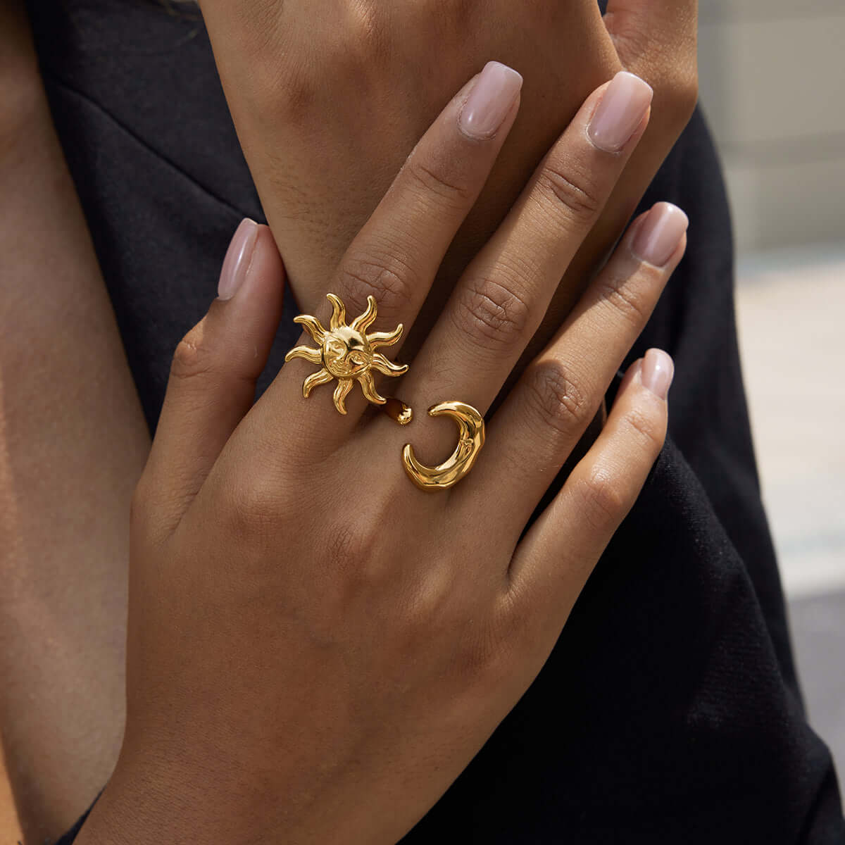 Chunky Gold Moon Ring worn with a sun ring, depicting a feminine and mystical aesthetic.