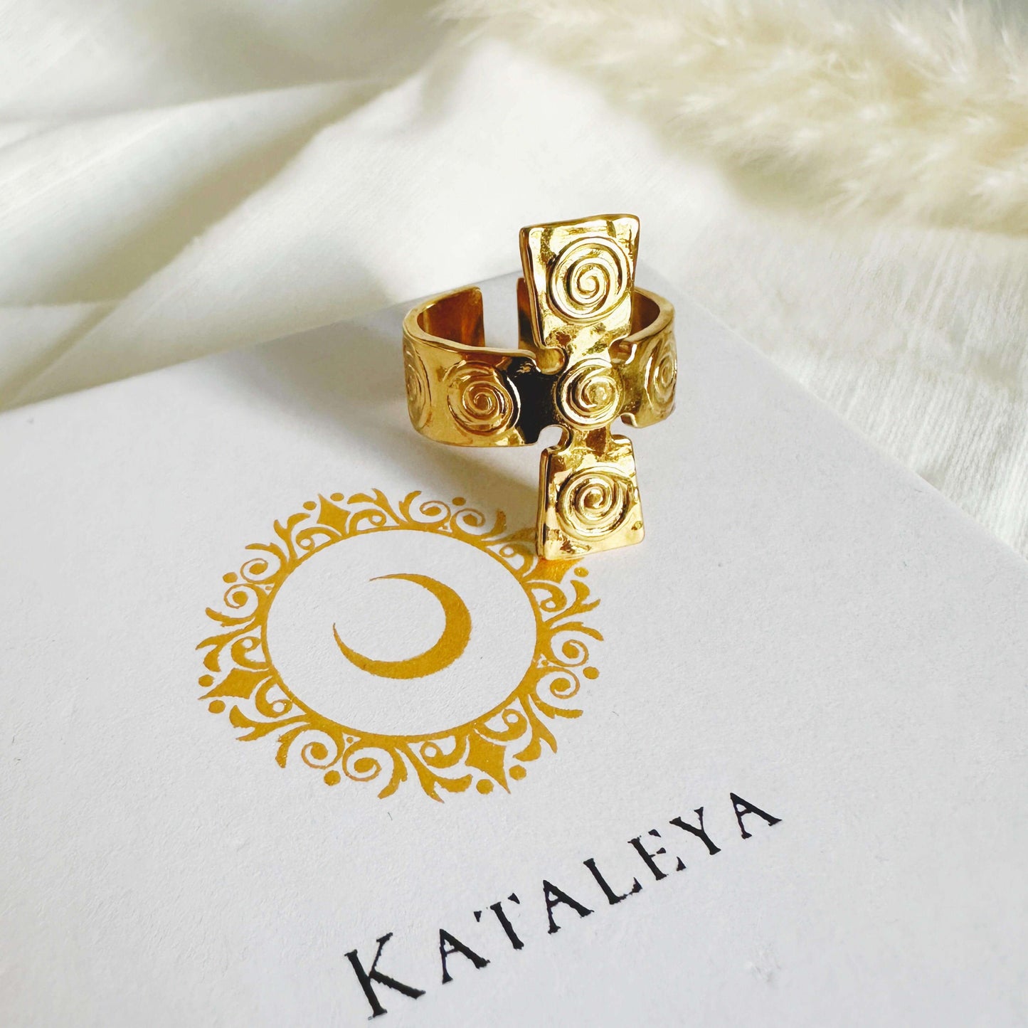 Stunning Cross Gold Ring with a spiral design resting on a branded Kataleya card.