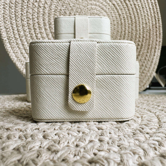 Pocket Jewellery Case in cream eco-friendly leather with gold button, designed for premium jewellery storage.