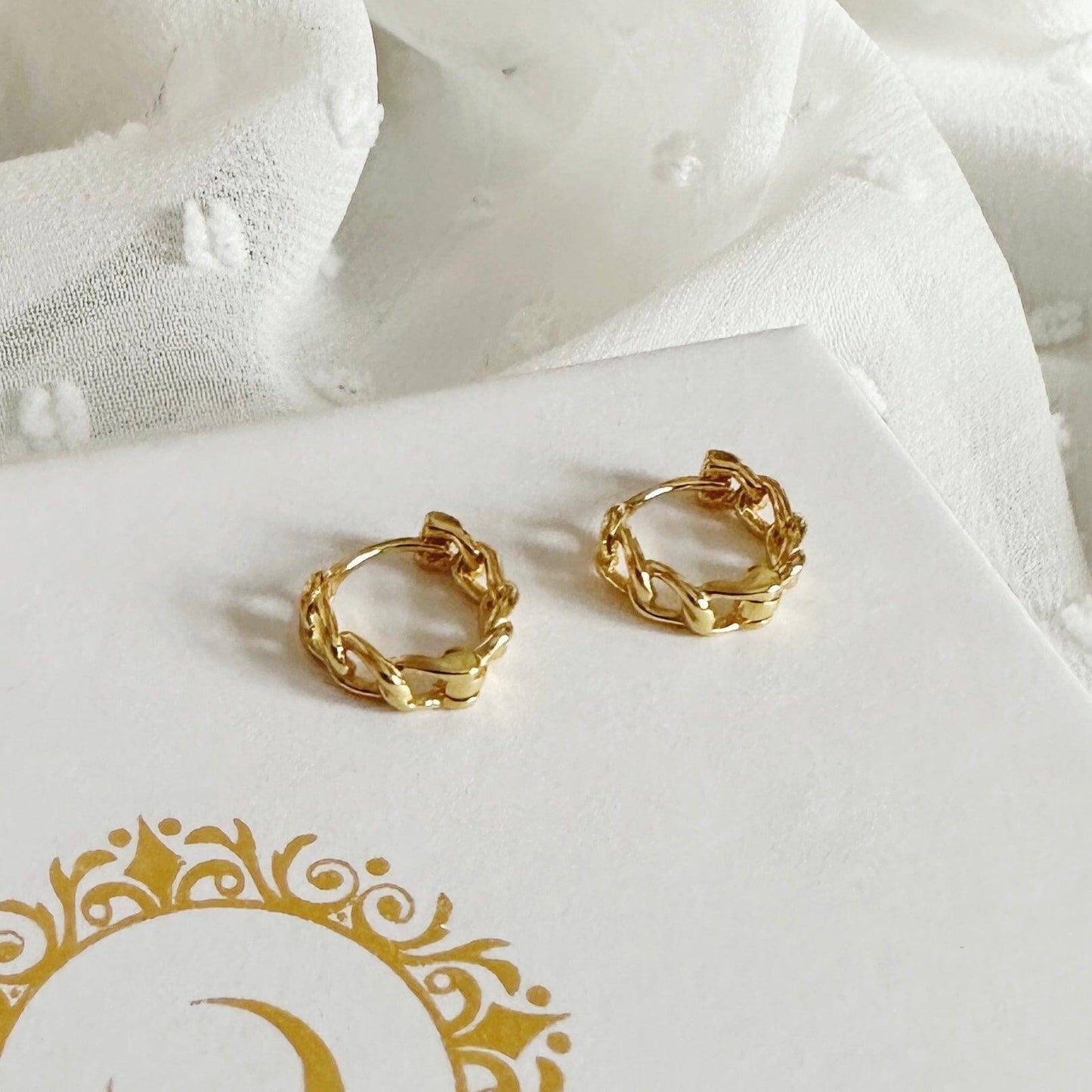 Stunning Simona Gold Jewellery Set featuring elegant gold-plated chain huggies on a soft textured background.
