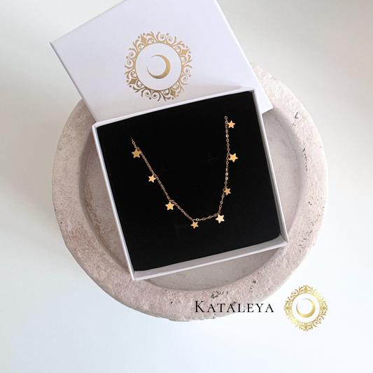 Star Charm Necklace displayed in elegant packaging with gold star charms on a delicate chain.