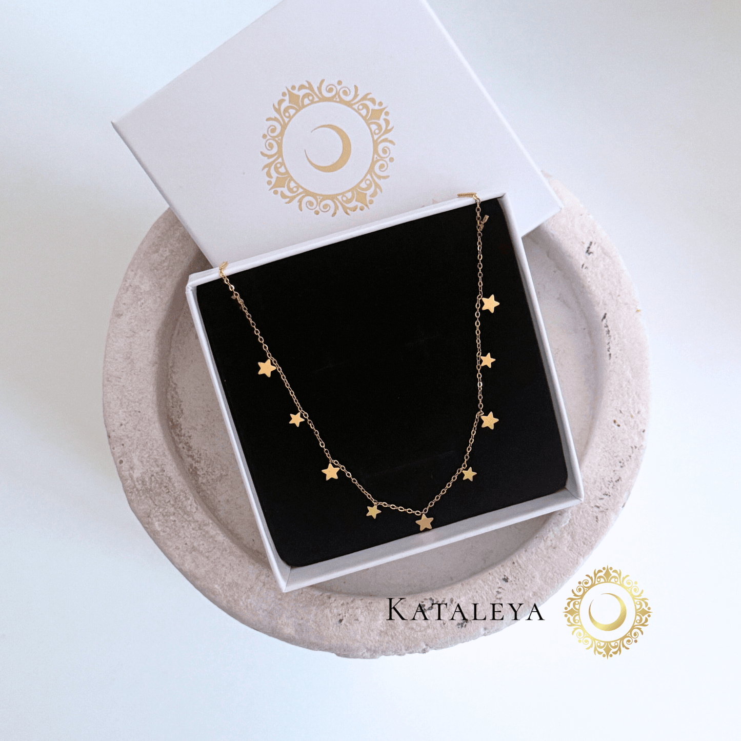 Star Charm Necklace displayed in a gift box with a black interior and golden stars on the chain.