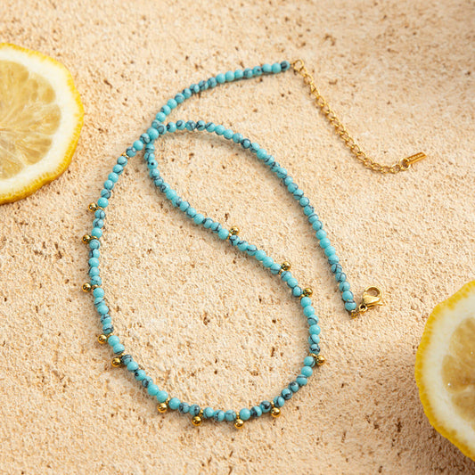 Nera Beaded Necklace featuring vibrant turquoise beads and gold detailing, perfect for summer styling, Turquoise Beaded Necklace.
